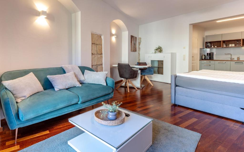 a living room with a couch and a bed at Ferienvilla Bad Schandau in Bad Schandau