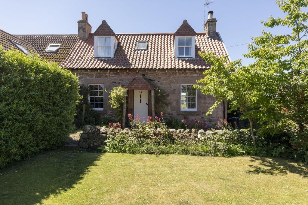 an old house with a garden in front of it at Windyrig in Cockburnspath