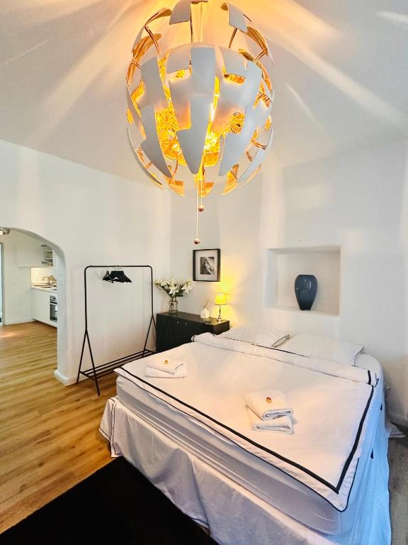 a bedroom with a bed and a large chandelier at White Oak Loft in Schottwien