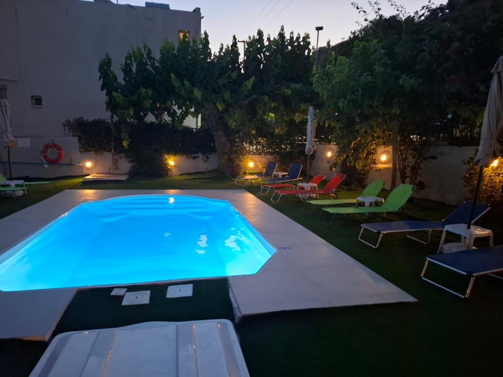 a swimming pool in a backyard with lawn chairs at Vivari Acta in Vivari