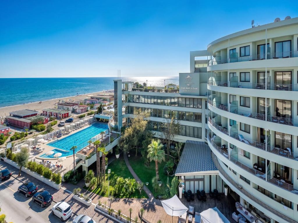 an aerial view of a resort with a pool and a beach at Hotel Le Palme - Premier Resort in Milano Marittima