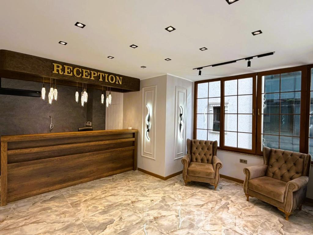 a salon with two chairs and a reception desk at Parfe Apart in Trabzon