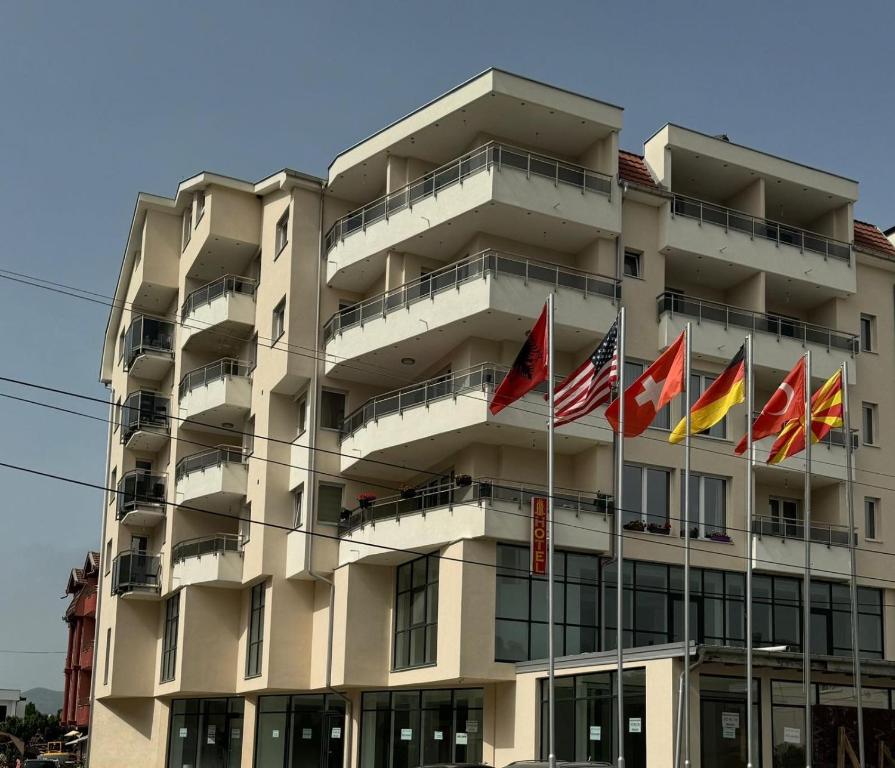 a group of flags in front of a building at Hotel Palace Struga in Struga