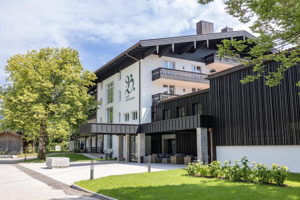 a building with a black and white facade at Bartl Apartments in Rottach-Egern