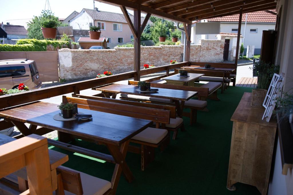 a row of tables and benches on a patio at Penzion u Bednářů in Pavlov