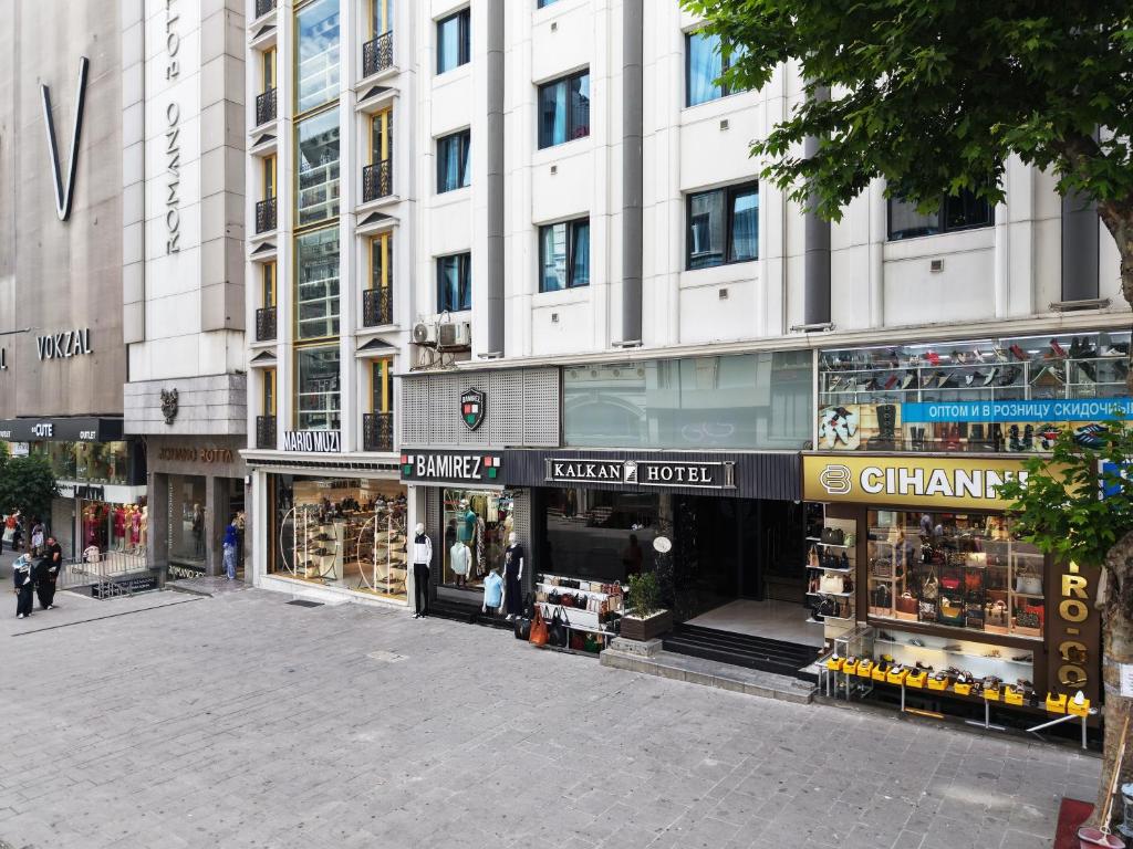 a city street with shops in front of a building at Kalkan Hotel in Istanbul