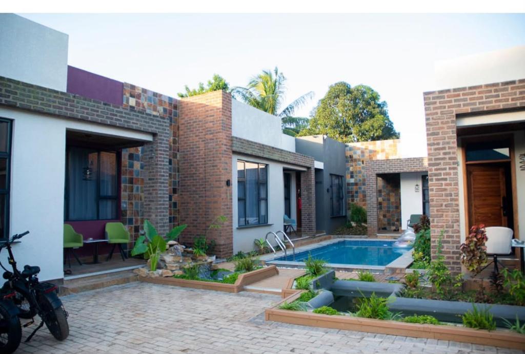 a courtyard of a house with a swimming pool at Juney Villas Zanzibar in Zanzibar City
