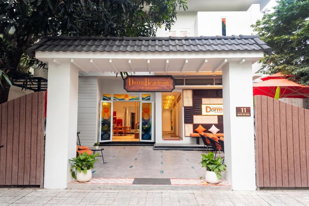 an entrance to a restaurant with a sign that reads nourishment at Dorm Beachside Hotel & Hostel By Haviland in Danang