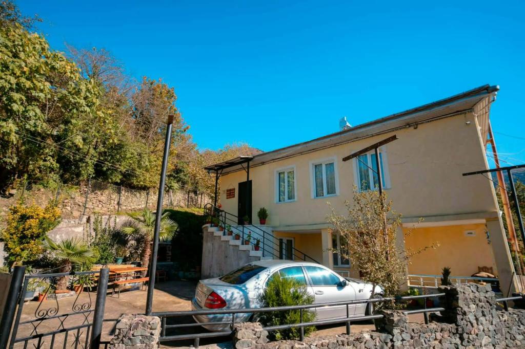 a house with a car parked in front of it at Sun ray in Ch'ik'unet'i