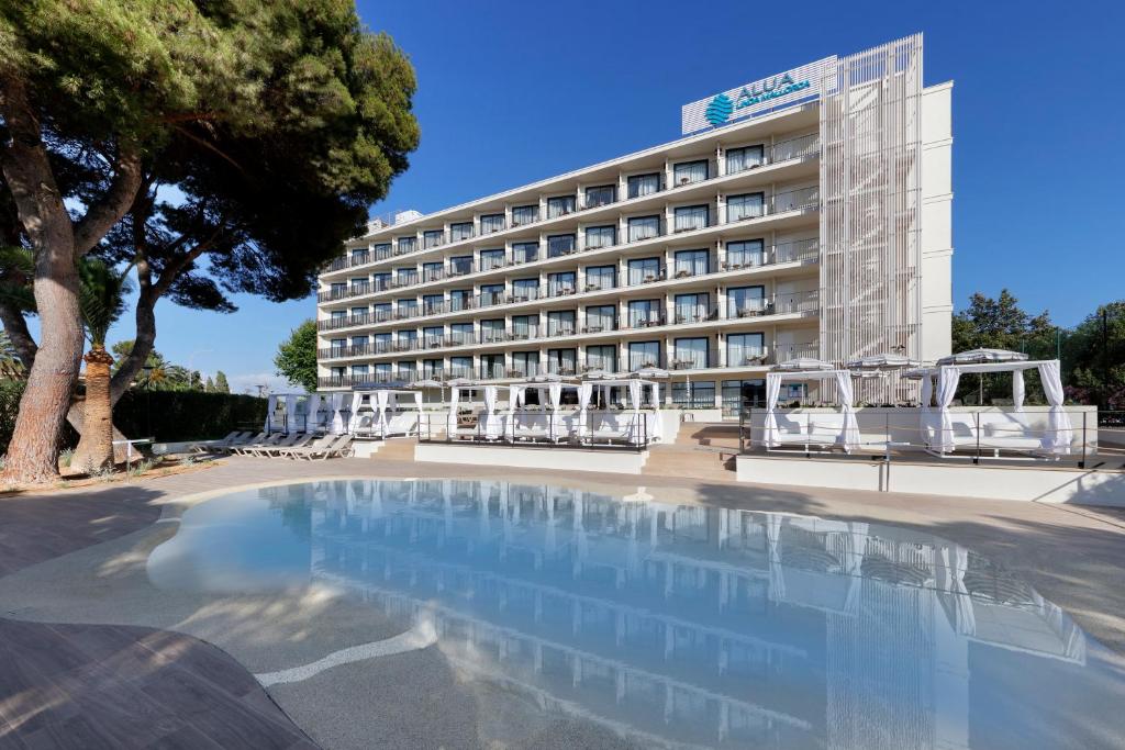 a hotel with a swimming pool in front of a building at Alua Linda Mallorca - Newly Renovated 2026 in Can Pastilla