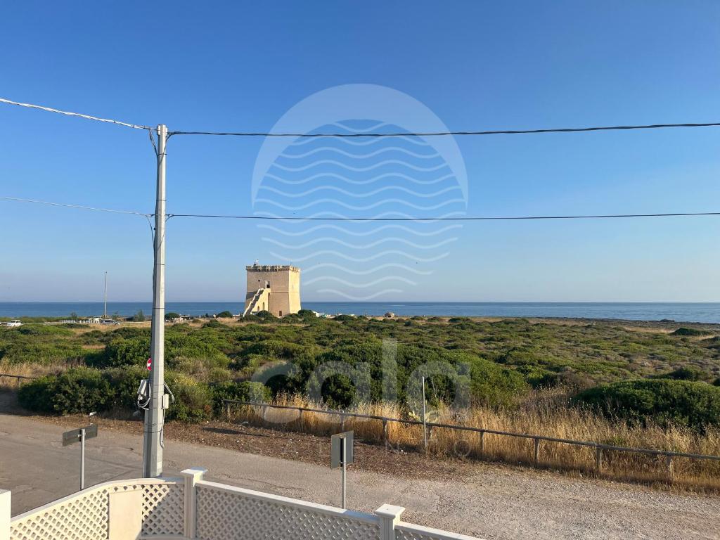 a wave mural on the side of a beach at La Torre - Piano Primo By Cala Salento in Torre Lapillo