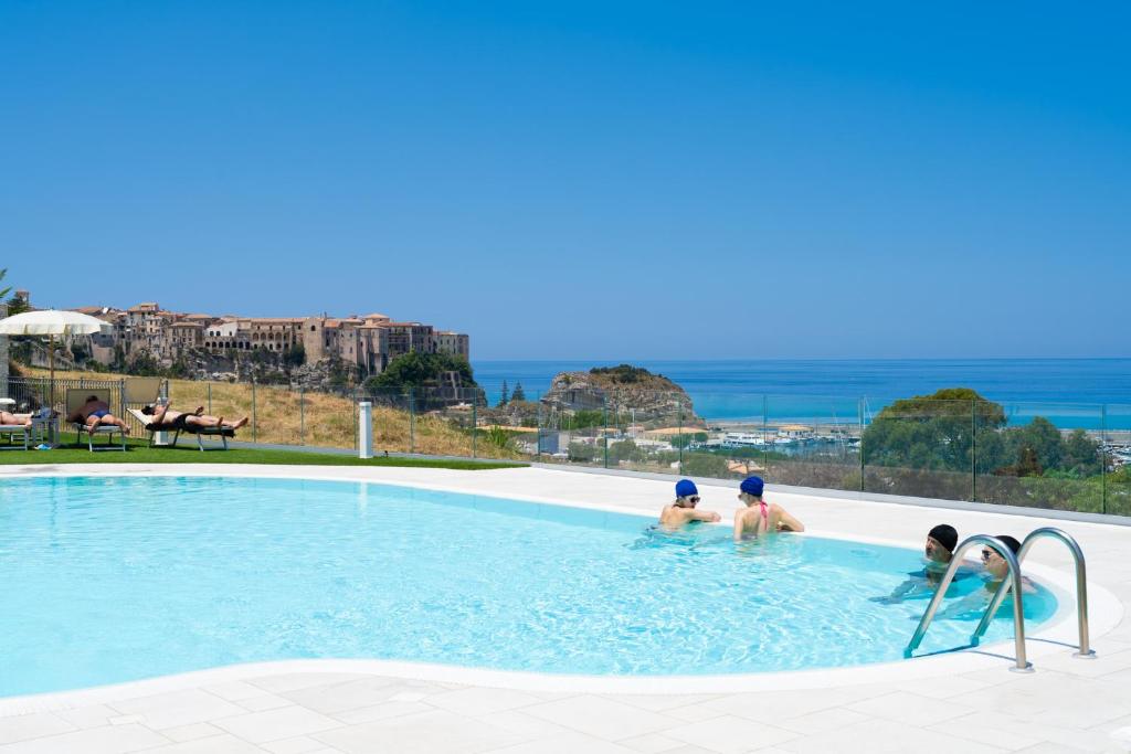 a group of three people in a swimming pool at Residence New Paradise in Tropea
