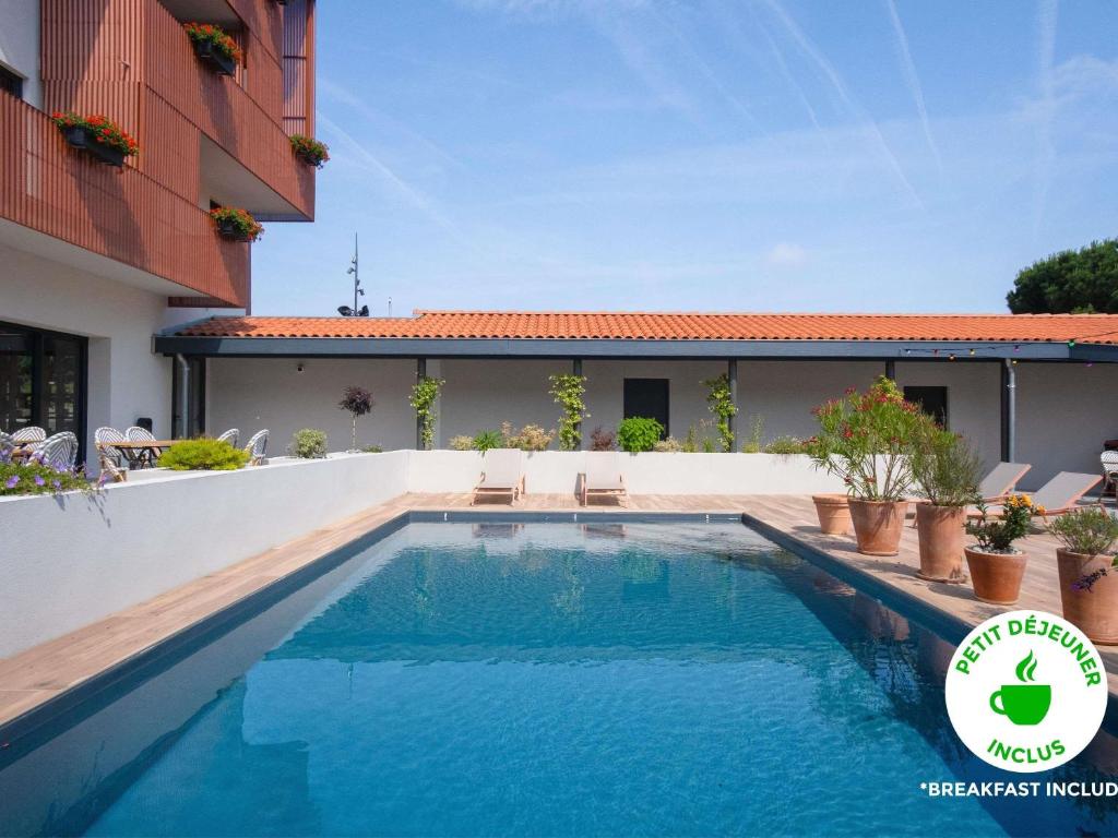 a swimming pool in the backyard of a house at ibis Styles Montauban in Montauban