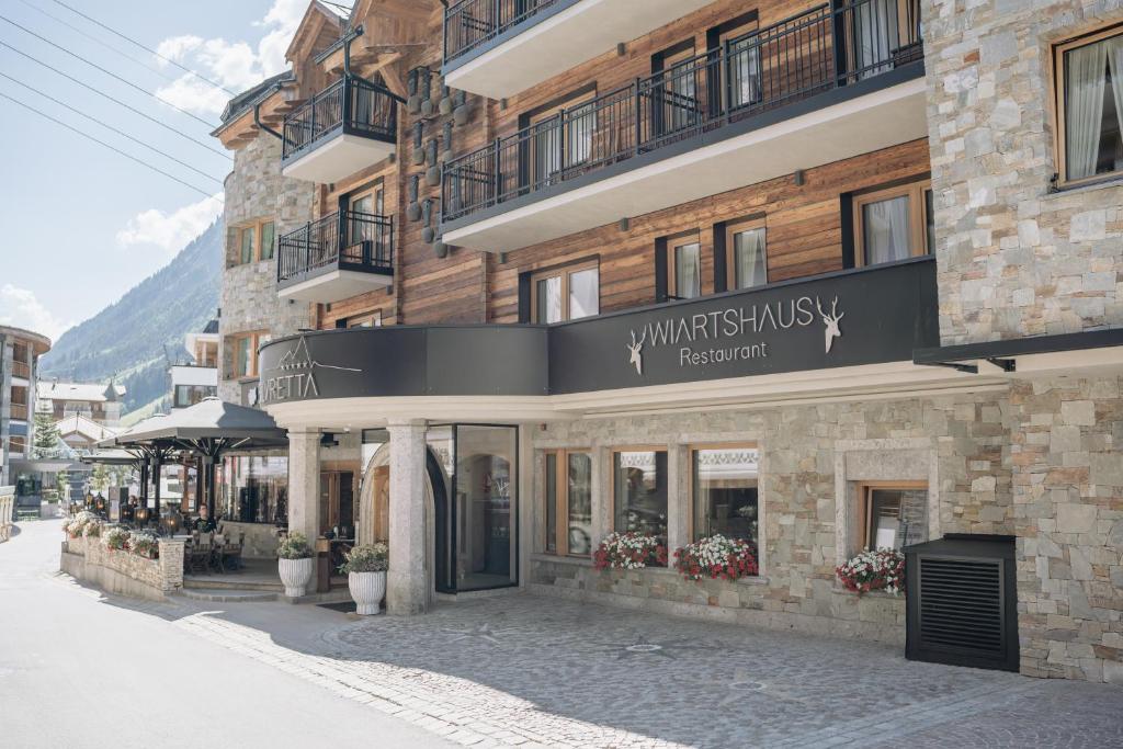 a building with a sign on the front of it at Sport- und Genusshotel Silvretta in Ischgl