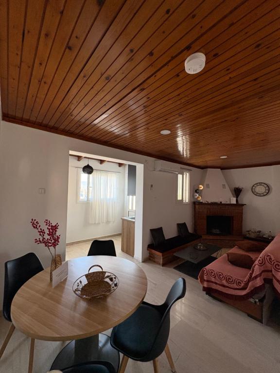 a living room with a table and a bedroom at Sisyphys Kingdom in Korinthos