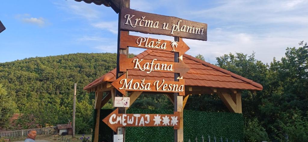 a sign for a restaurant with signs on it at Krčma u Planini in Bojnik