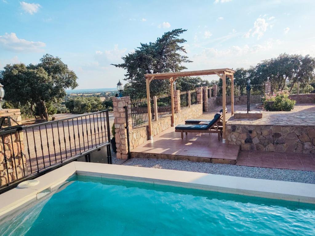 a swimming pool with a gazebo next to at VILLA CERRO MORENOVilla privada con piscina en finca exclusiva a 10 min de Lagunas de Ruidera in Ossa de Montiel