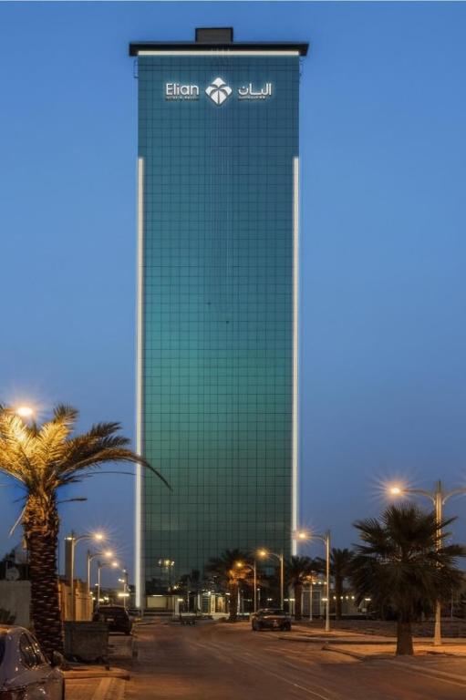 a tall building with a sign on the side of it at Elian Tower AlSahafa Hotel in Riyadh