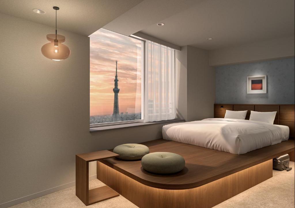a bedroom with a large bed and a window at B:CONTE Asakusa in Tokyo
