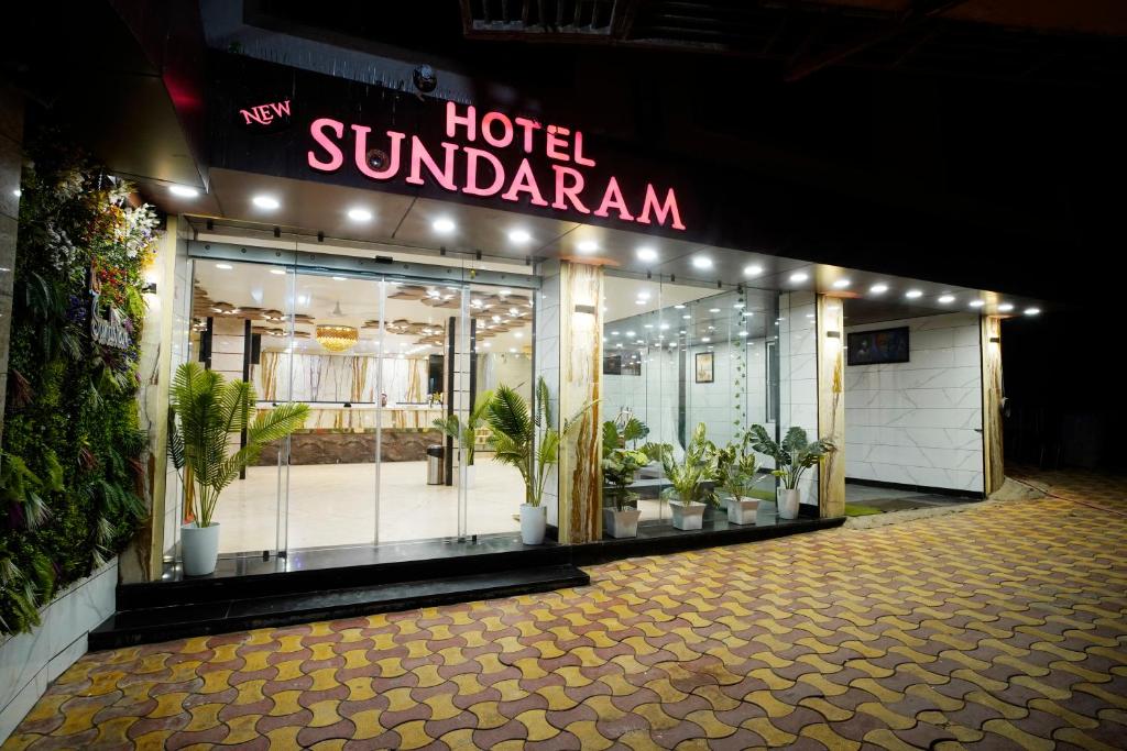 a hotel sunadiyan with potted plants in front of a store at Hotel New Sundaram 150 Mtrs from Dargah in Ajmer