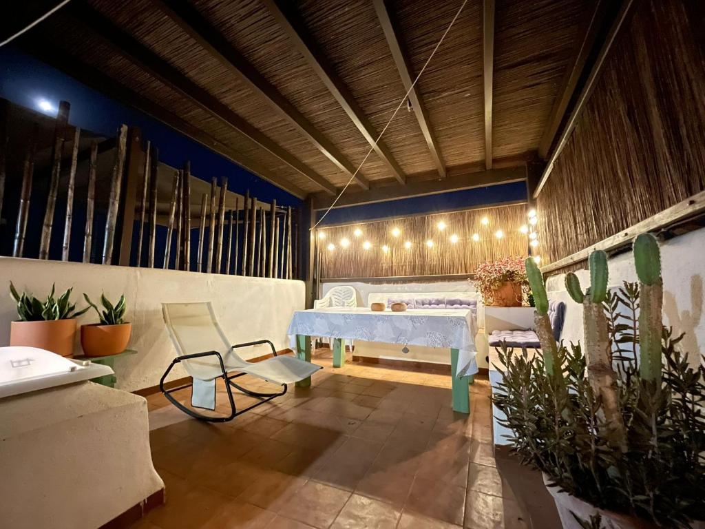 a room with a table and some plants and lights at Casa Mellis Aguamarga in Agua Amarga