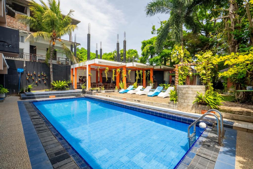 a swimming pool in front of a hotel at The Panorama Negombo in Negombo