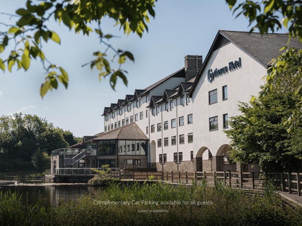 a large white building next to a river at Copthorne Hotel Cardiff-Caerdydd in Cardiff