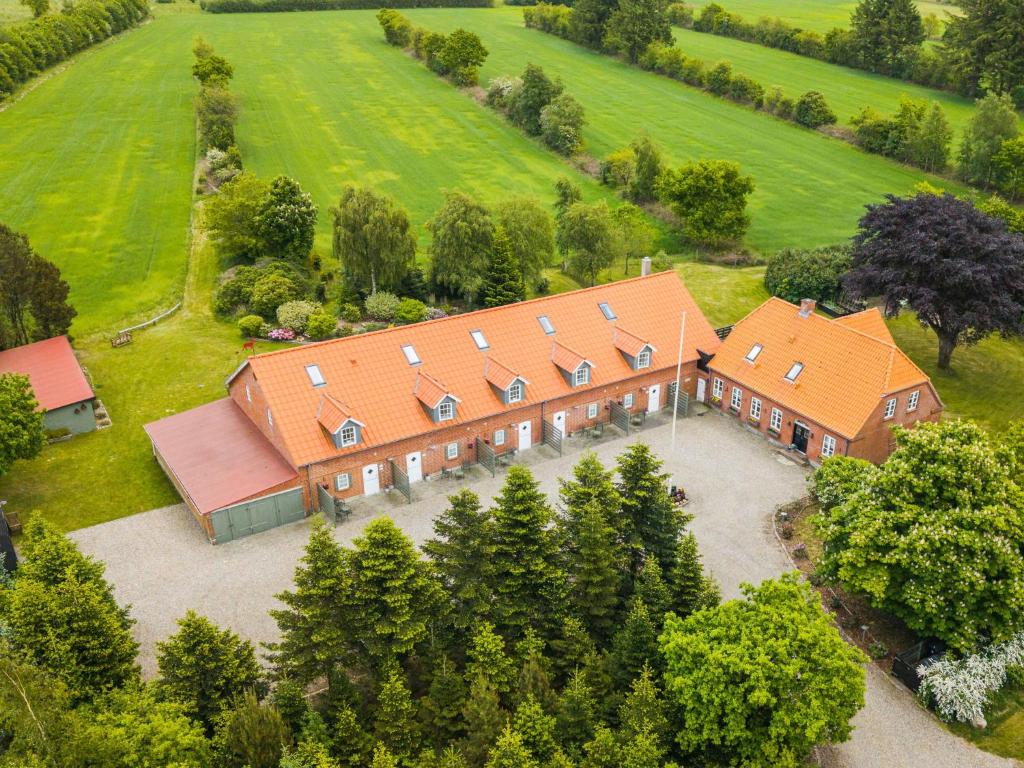 an aerial view of a large house with an orange roof at Lustrup Farmhouse in Ribe
