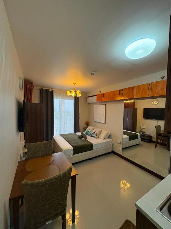 a hotel room with a bed and a desk and a room at At LBS 888 Condo Unit Rental-Full Relaxing Seaview 304-10Flr in Lapu Lapu City