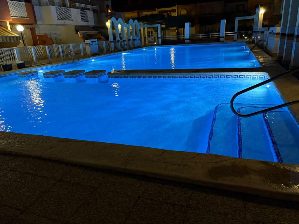 a large blue swimming pool with a hose in it at Casa del Sol - Santiago de la Ribera, San Javier, 600 m from the beach, swimming pool in San Javier
