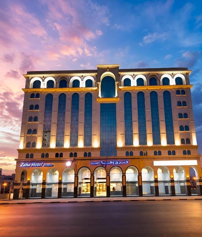 a large building with a blue and white building at Zaha Al Madina Hotel in Medina