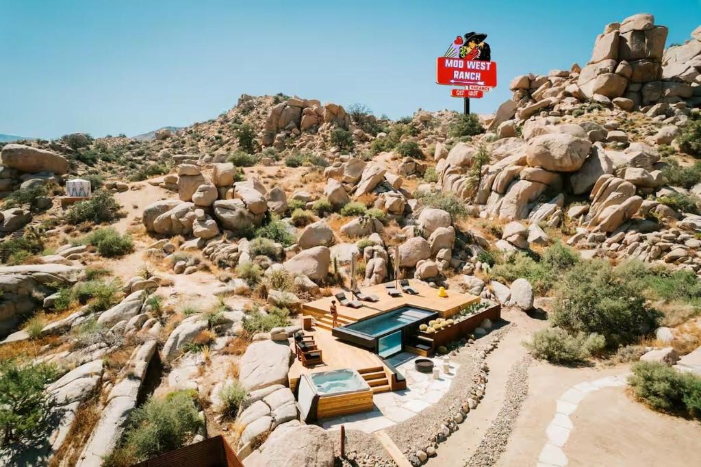 a model of a mountain with a sign on it at Mod West Ranch: 5-acre Boulder Playground in Pioneertown
