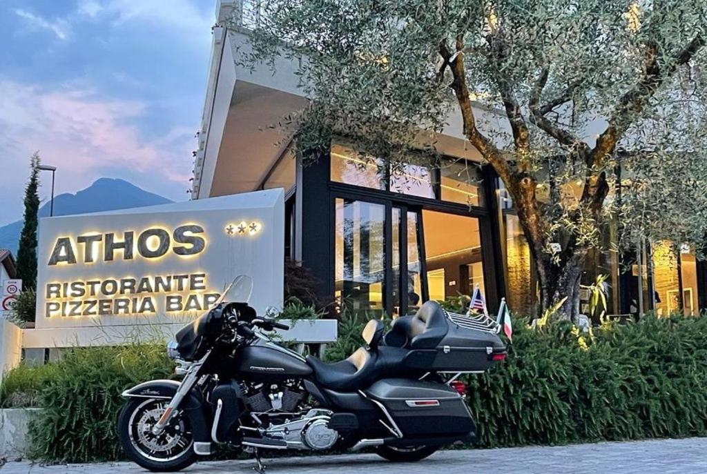 a motorcycle parked in front of a pizza bakery at Athos Hotel in Riva del Garda