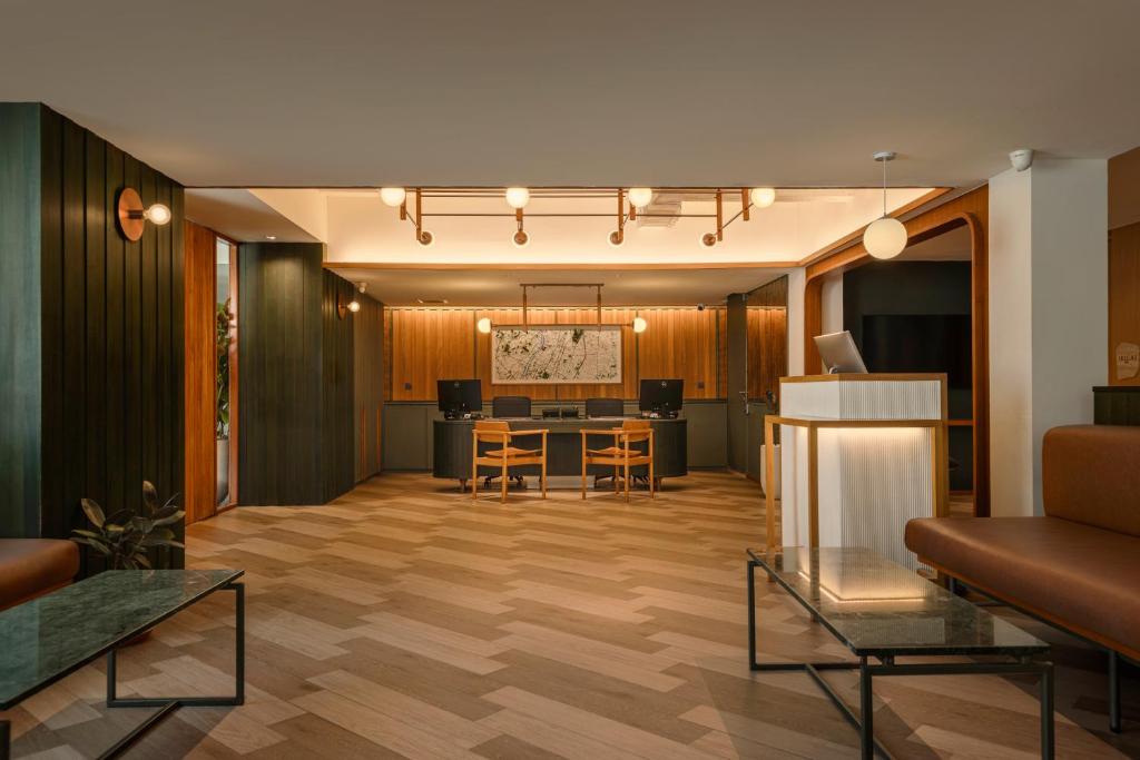 A warm shared lounge and reception area with workstations and a large wall map.
