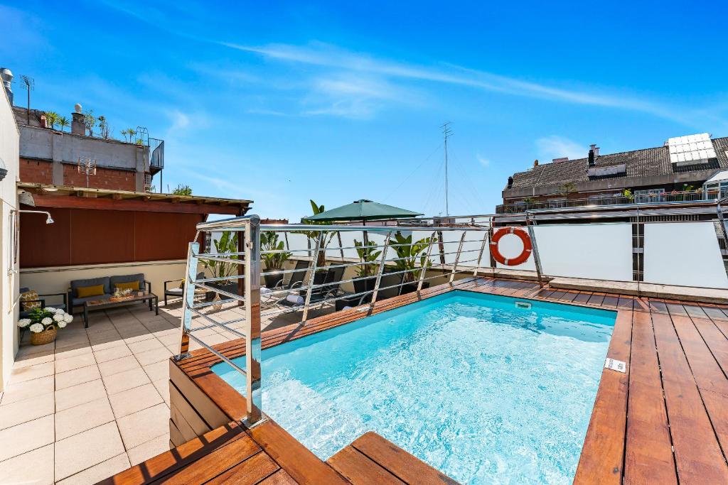 a swimming pool on the roof of a building at Acacia Suite in Barcelona
