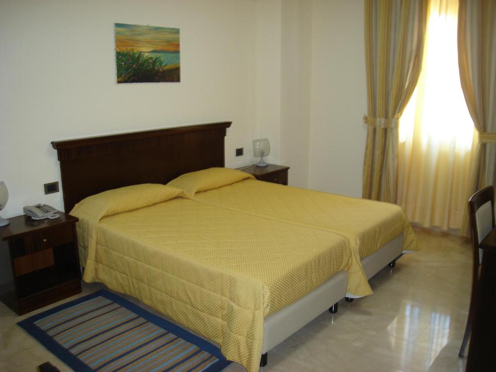 Postel nebo postele na pokoji v ubytování Hotel Le Palme