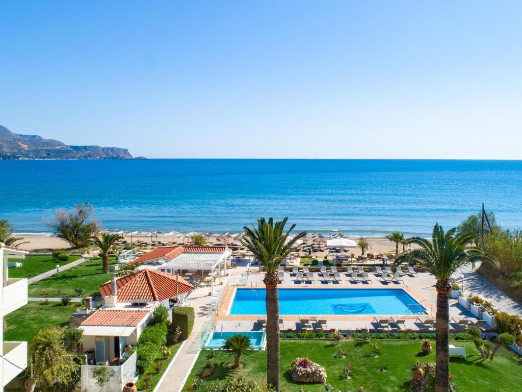 an aerial view of a resort with a swimming pool and the ocean at GK Beach Hotel in Kalyves
