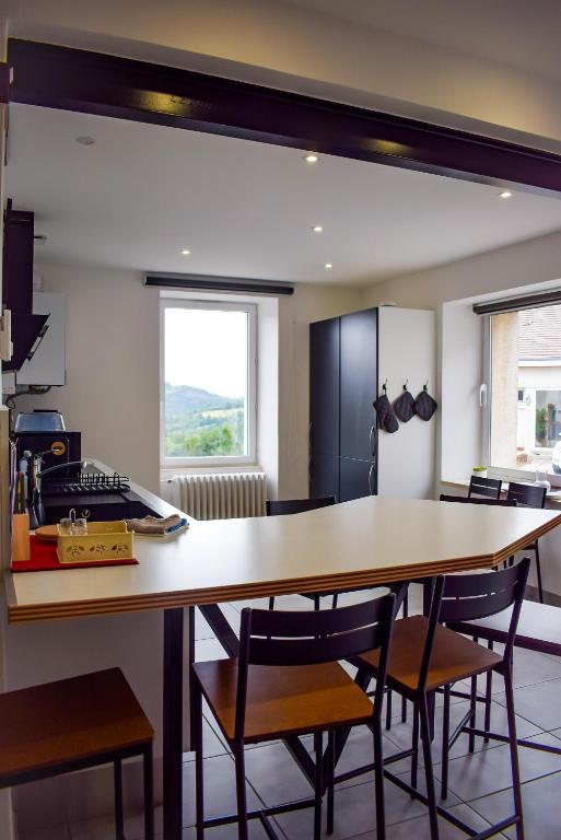 a kitchen with a large wooden table and chairs at L'atelier de Mathieu meublés de tourisme classés in Saint-Rémy-sur-Durolle