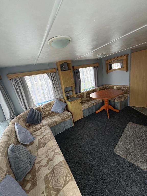 a room with a bed and a table in a train at 137 sealands, 3 bed, 8 berth caravan hire, ingoldmells, skegness recently modernised in Ingoldmells