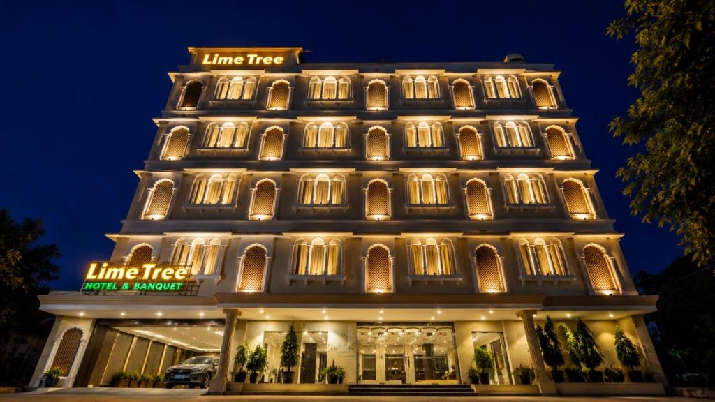 a building lit up at night at Lime Tree Hotel & Banquet Jal Mahal Jaipur in Jaipur