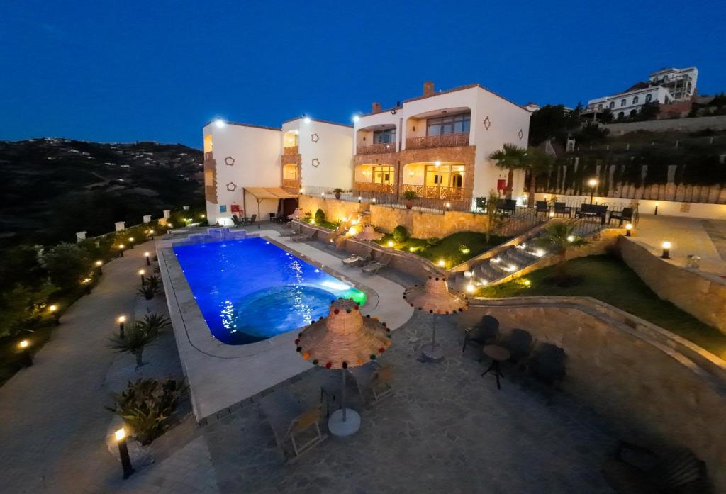 an overhead view of a swimming pool at night at Oussoul House in Feddane Saïdi