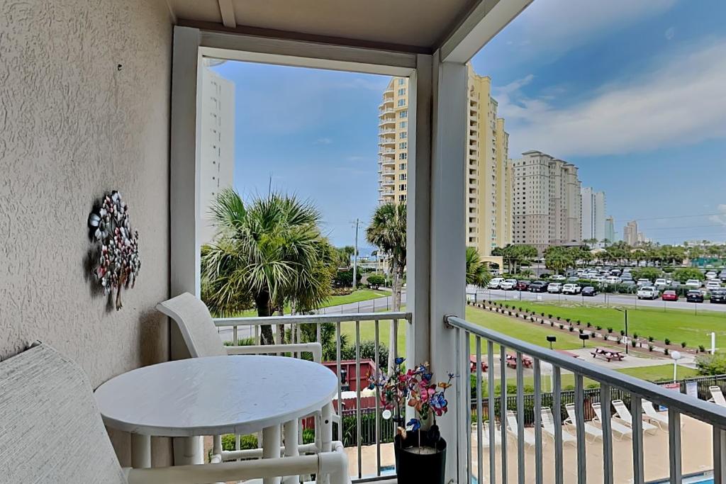 a balcony with a table and a view of a city at Grand Caribbean Perdido Key #306 West in Perdido Key