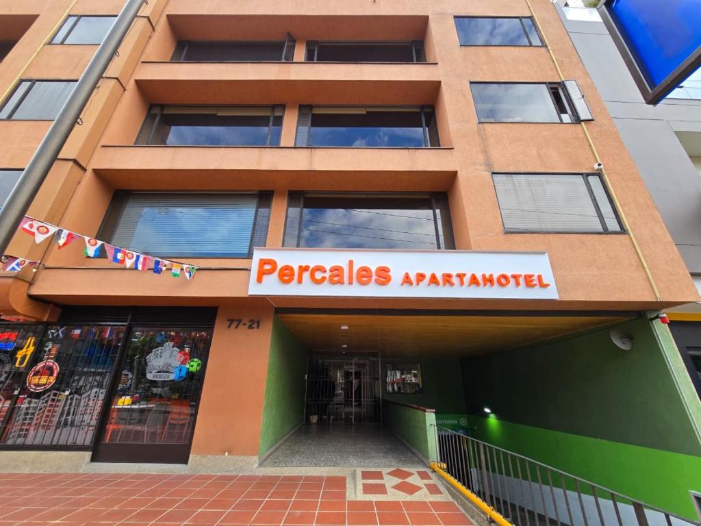 a building with a sign that reads pagogias xmas market at Apartamentos Percales in Bogotá