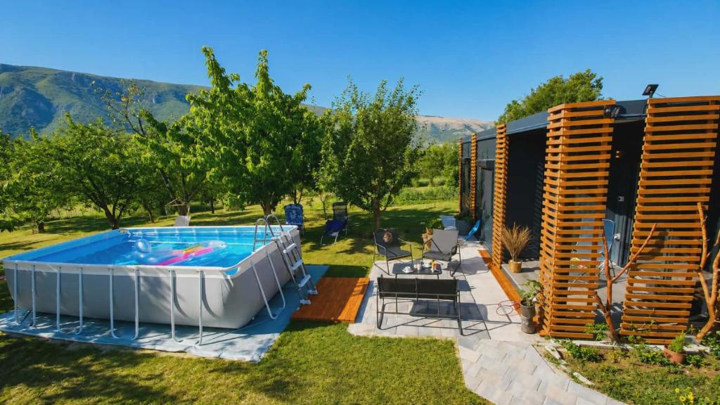 a backyard with a swimming pool and a house at Resort-Music Mostar in Potoci