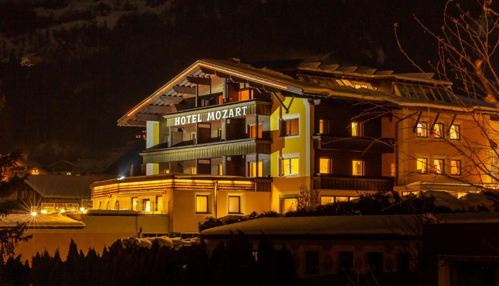 a hotel building with a sign on it at night at Hotel Mozart in Landeck