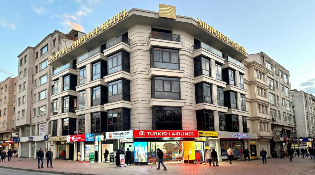 a building on the corner of a street with people at Istanbul Midpoint Hotel in Istanbul