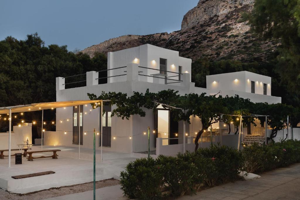 a white house with a mountain in the background at Mazi in Sifnos in Sifnos