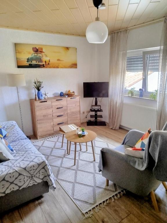a living room with a couch and a table at Wünschel Stube in Gossersweiler-Stein