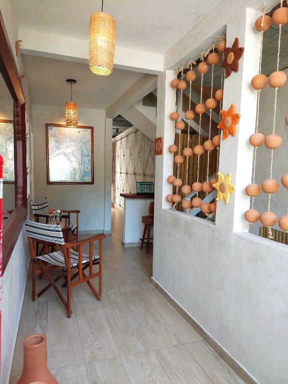 a living room with a table and a dining room at Villamar Pousada in Morro de São Paulo