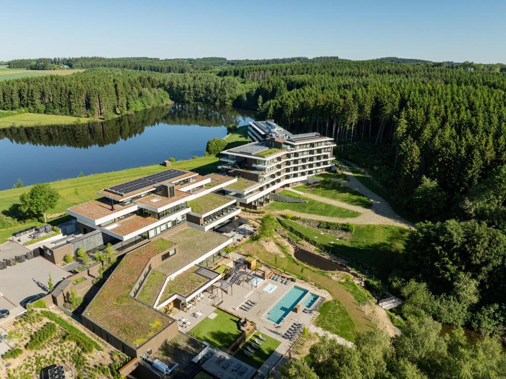 an aerial view of a building next to a lake at Anatura Hotel Luxembourg in Weiswampach